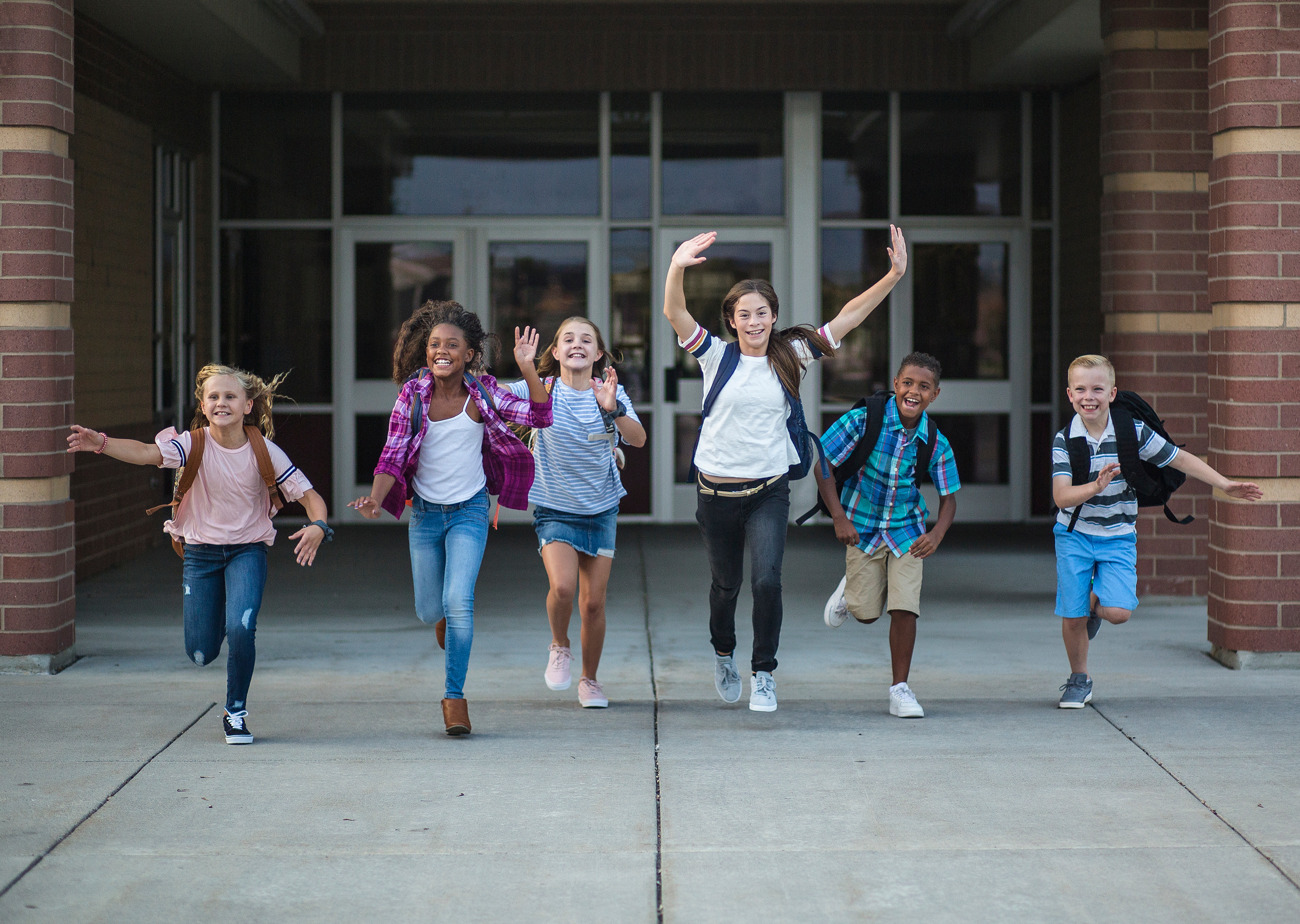 Children with backpacks walking from school