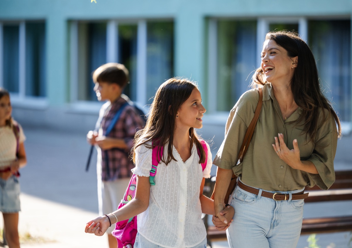 Happy parent picking up child from school